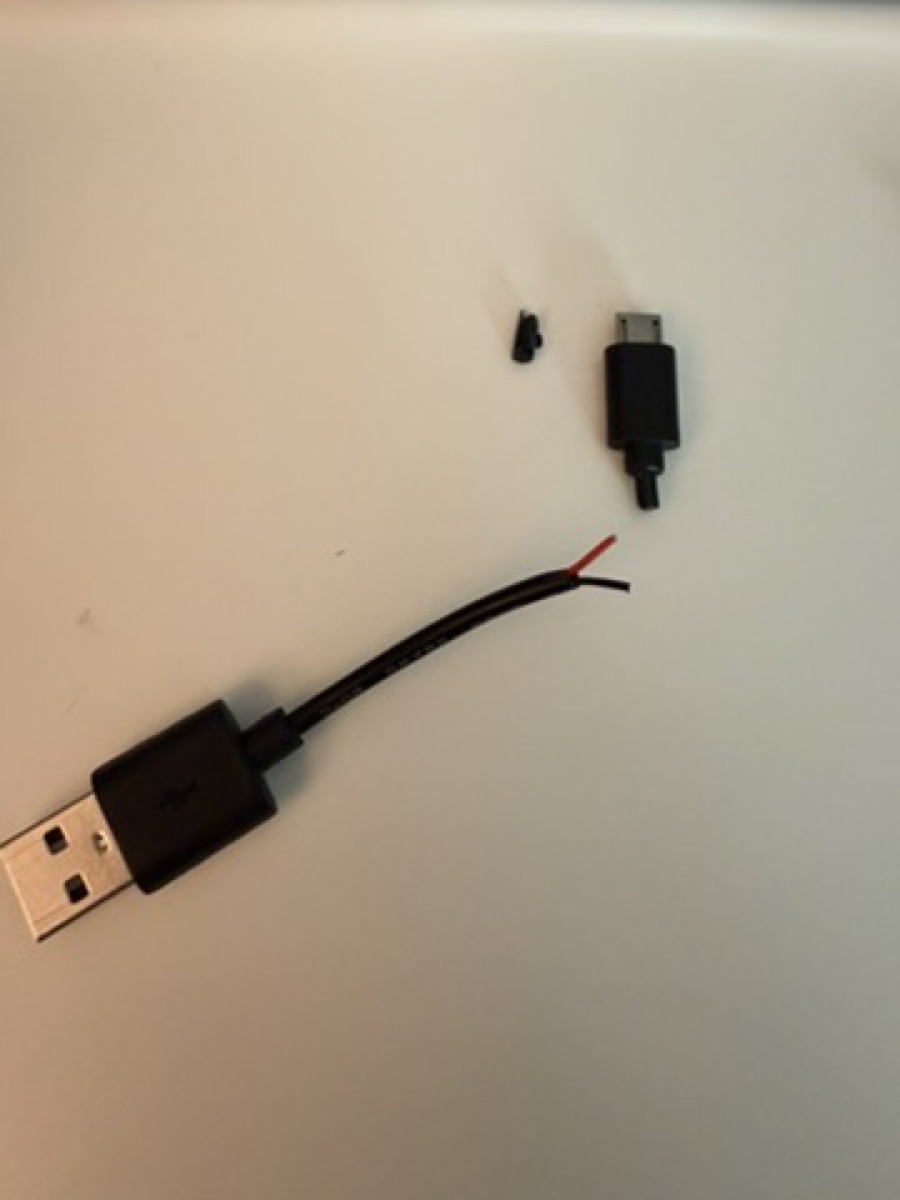 cut-open micro USB cable revealing only two wires — power, no data