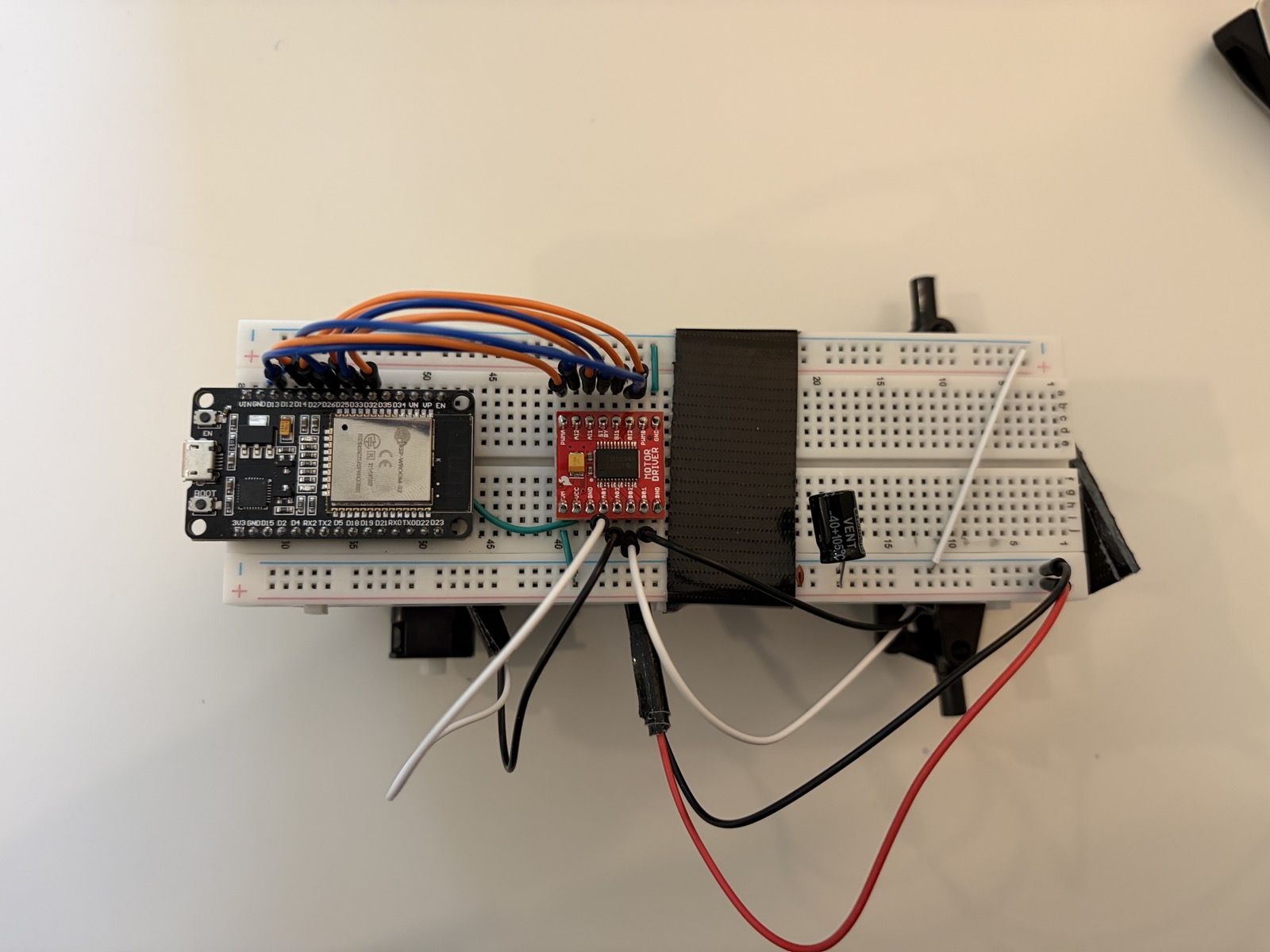 the complete circuit — ESP, motor controller, motors, and battery all wired up